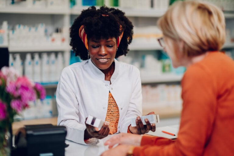 pharmacist serving patient at the pharmacy counter