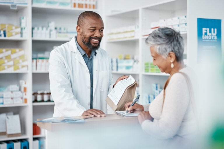 pharmacist helping patient with medication at the pharmacy counter